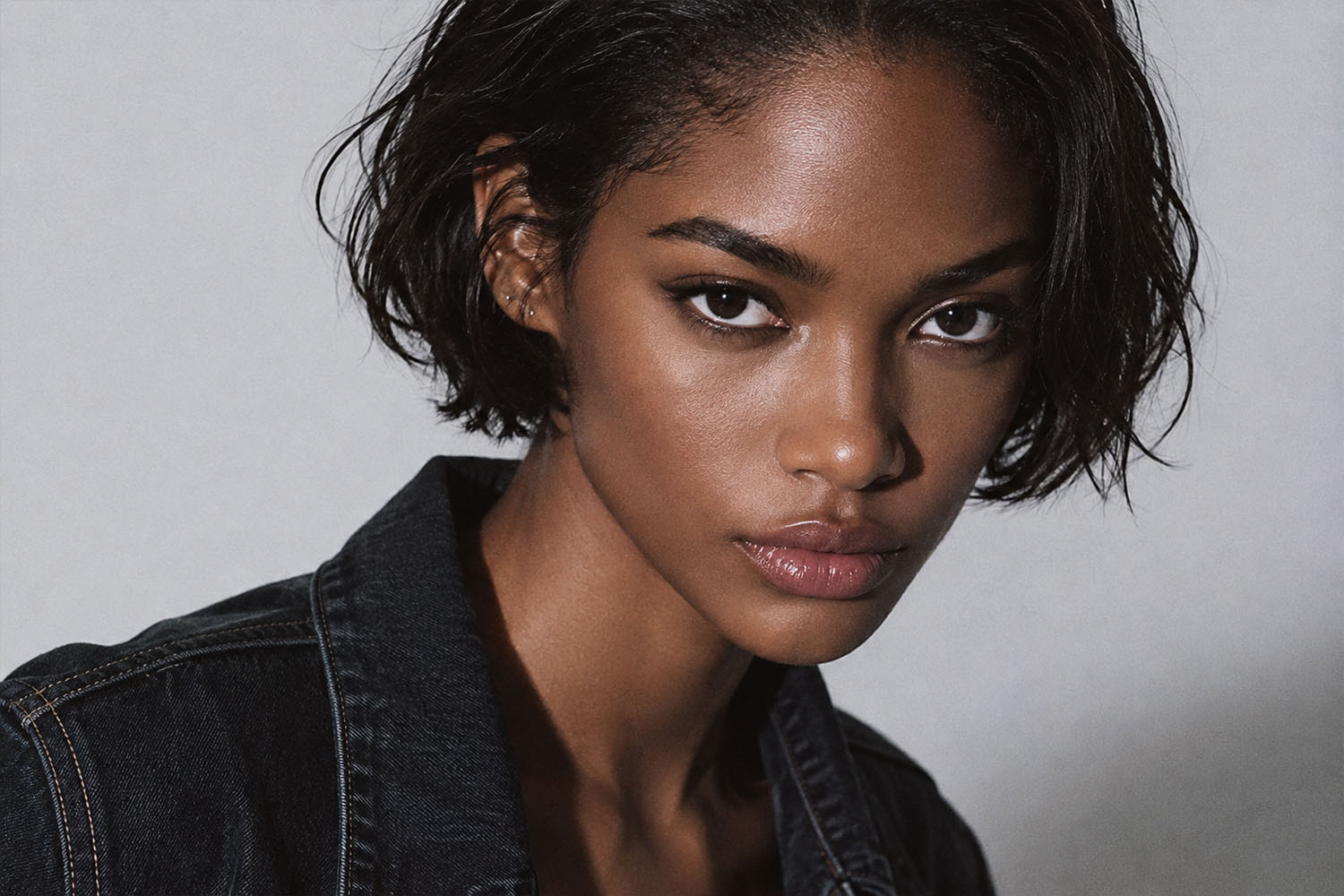 Black woman wearing a short natural-looking human hair wig